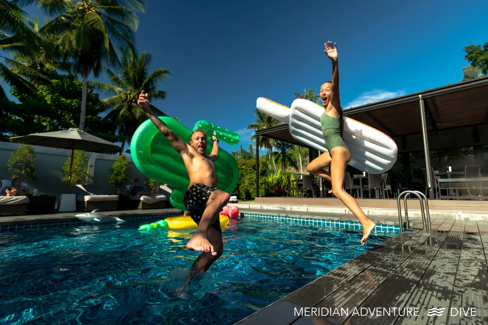 Guests enjoying a land-based stay at a Raja Ampat resort pool