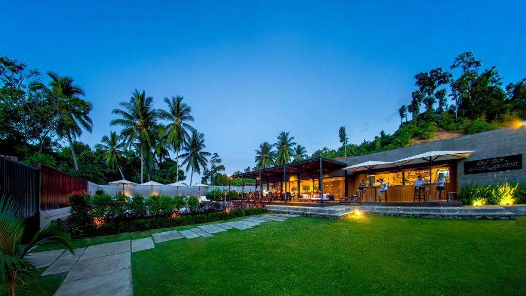 Meridian Adventure Dive Resort at night in Raja Ampat supporting responsible tourism
