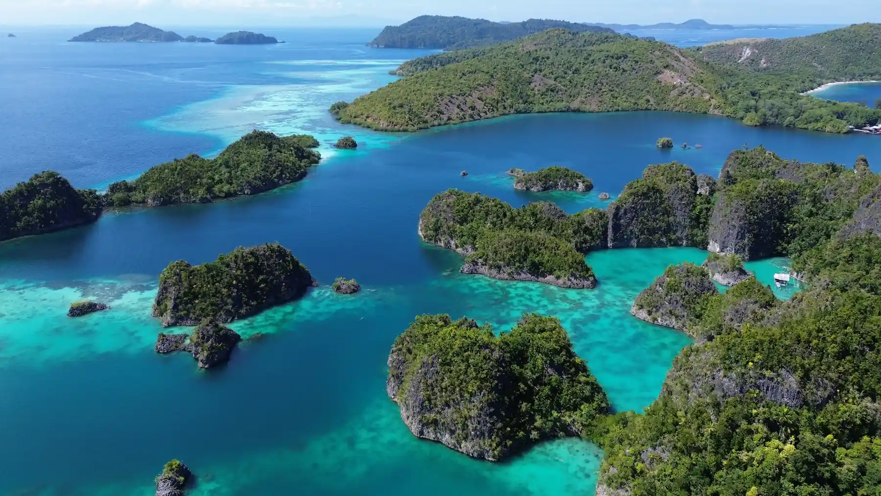 What to Pack for Raja Ampat aerial view of limestone islands and turquoise lagoons in Southwest Papua