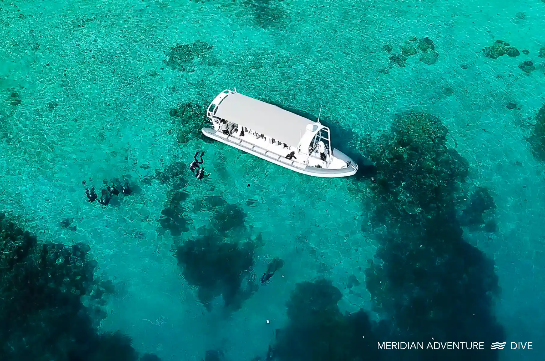 Meridian Adventure dive boat supporting scuba divers at a Raja Ampat dive site